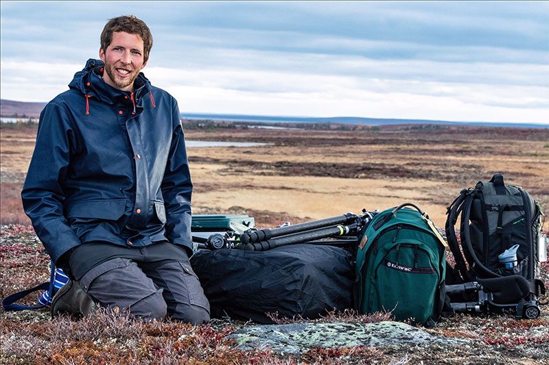 Nansen Weber on the tundra awaiting a helicopter pickup