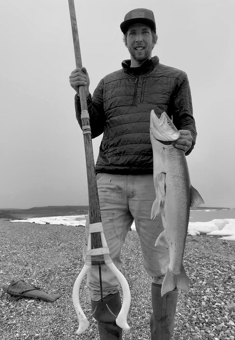 Nansen with a char that he caught with a traditional spear